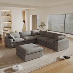 a living room with a sectional couch and footstool in the middle of it