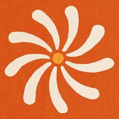 an orange and white flower is shown on the side of a piece of paper that has been cut out