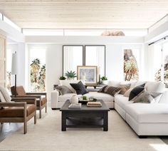 a living room filled with lots of white furniture