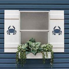 the window is decorated with blue crabs and green plants