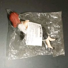 a doll laying on top of a plastic bag