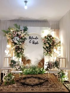 a wedding ceremony setup with flowers and greenery