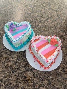 two heart shaped cakes sitting on top of plates