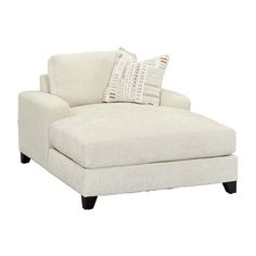 a white chaise lounge chair with pillows on it