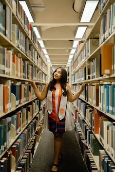 a woman standing in the aisle of a library