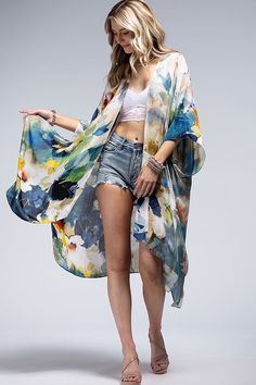 Wrap yourself in elegance with our Watercolor Open Front Kimono! Featuring a delicate and light watercolor effect, this kimono is perfect for everyday wear. One size fits most, making it versatile to layer over jeans, a maxi dress, or even a swimsuit. Crafted from lightweight, flowing fabric, it's the perfect addition to your wardrobe. 100% Viscose Length: 38" Width: 40" One Size Fits Most Watercolor Print Open Front Cover Up Blue Breezy Summer Cover-up, Blue Breezy Flowy Cover-up, Blue Flowy Breezy Cover-up, Chic Unlined Spring Cover-up, Oversized V-neck Spring Cover-up, Chic V-neck Summer Kimono, Chic Spring Unlined Cover-up, Summer Floral Print Wrap Cover-up, Spring Flowy Wrap Cover-up