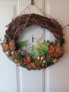 a wreath with butterflies hanging from the front door and moss growing on it's sides