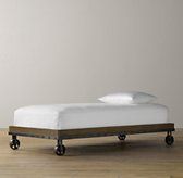 a bed sitting on top of a wooden floor