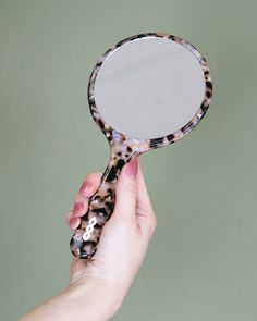 • 1 cellulose acetate hand mirror • Mirror is standard 1x reflection, 4.25” diameter • White logo on inside handle • 4.75” x 9.5”, 7mm thickness • Cellulose acetate is a natural, biodegradable bioplastic made mostly from wood pulp. Durable, flexible and anti-static, with natural variation in color and pattern. Hand Held Mirror, Women's Hair Accessories, Rock Hand, Handheld Mirror, Vintage Packaging, Cellulose Acetate, Hand Mirror, River Rock, Women's Hair