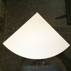 a white piece of paper sitting on top of a black counter next to a toilet