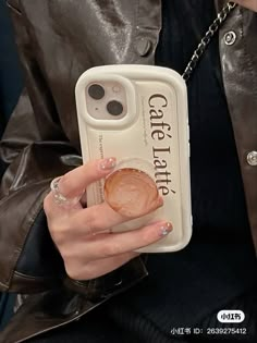 a woman is holding up her phone case