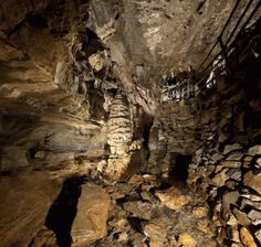 the inside of a cave with many rocks and wires hanging from it's sides