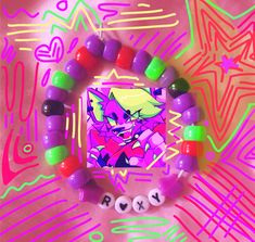 a bracelet made out of candy and beads with an image of a cat on it