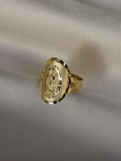 DESCRIPTIONA statement ring if we ever saw one. This ring features the virgin Mary looking rather stunning on a wide band. Guaranteed to have people staring at your... hands. This piece requires custom sizing, making it final sale. DETAILS- always made in 14k gold