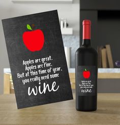 a bottle of wine next to a card that says apples are great apples are fine but at this time of year you really need some wine