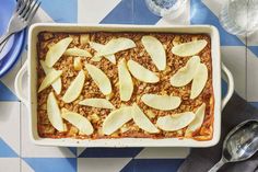 an apple and oatmeal casserole on a blue and white checkered tablecloth