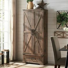 a wooden cabinet sitting next to a window in a room with white walls and furniture