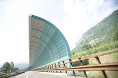 an image of a curved road with mountains in the background