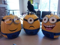 three yellow and blue pumpkins with faces on them