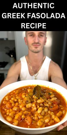 a man holding a bowl of food with the words authentic greek fasolada recipe