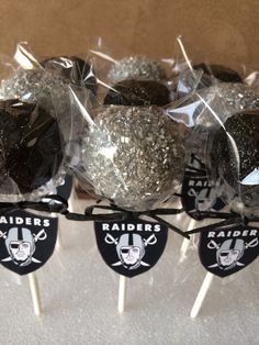 there are some football candies wrapped in plastic and tied together with black and white ribbon