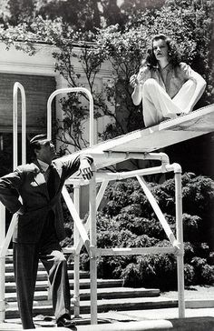 an old black and white photo of two people on stairs