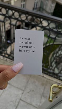 someone holding up a card that says, i attract incredible opponents in to my life