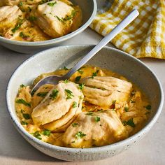 two bowls filled with chicken and cheese soup