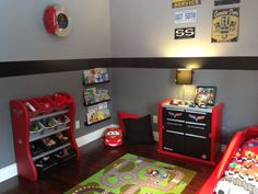 a child's room with cars themed furniture and decor on the walls, including toys