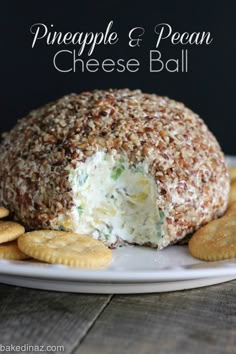 a cheese ball on a plate with crackers around it and the words pineapple & pecan cheese ball