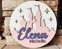 a sign that says elana michelle with a castle in the background and stars on it