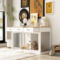 a living room with white furniture and pictures on the wall above it's console table