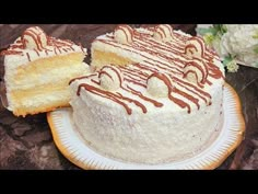 a white cake with chocolate drizzled on it sitting on top of a plate