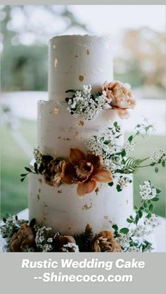 a three tiered cake with flowers and greenery on top