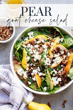 pear goat cheese salad in a white bowl with pecans and apples on the side