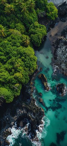 an aerial view of the ocean and rocks