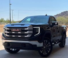 a black truck is parked in the driveway