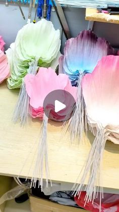 paper flowers are being made on a table