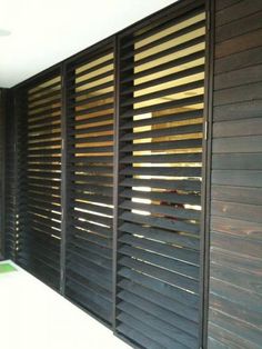 an outdoor area with wooden slats on the wall