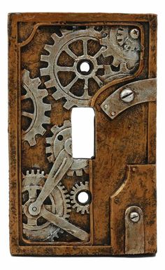 an old light switch cover with gears on the front and back covers in rusted metal