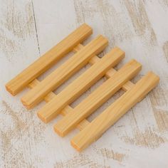 four pieces of wood sitting on top of a wooden floor