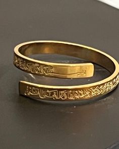 "Elegant and beautiful high quality Accessories:  The ring has \"ayatul-kursi\" \"  Throne Verse\" engraved in Arabic | gold Color | Islamic  Gift | Islamic  ring adjustable  gold Color Alloy ring for women. For your personal use or as a great gift.  Perfect for islamic accessories , featuring Adjustable ring.  Material: High quality alloy metal one size ring that is adjustable" Traditional Adjustable Engraved Ring, Traditional Adjustable Engraved Etched Ring, Adjustable Traditional Engraved Etched Ring, Adjustable Gold Engraved Ring, Gold Engraved Adjustable Ring, Traditional Adjustable Engraved Ring For Anniversary, Adjustable Traditional Engraved Ring As Gift, Gold Adjustable Engraved Spiritual Ring, Adjustable Gold Engraved Spiritual Ring