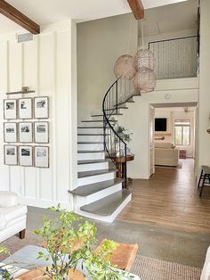 a living room filled with furniture and a spiral staircase