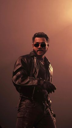 a man in black leather jacket and sunglasses