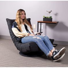 a woman sitting in a chair with her legs crossed