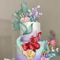 there is a multi layer cake decorated with flowers and ariel the little mermaid on it