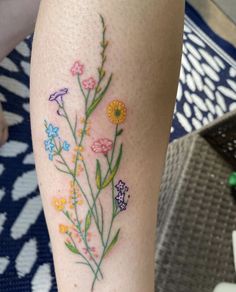 a woman's leg with flowers painted on it