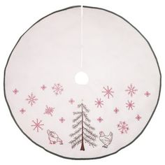 a white christmas tree skirt with pink snowflakes and birds on it, hanging from a wire