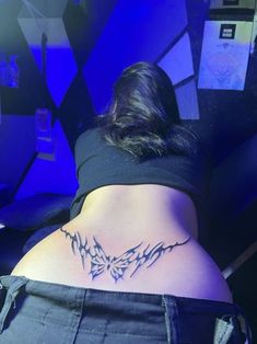 a woman with a tattoo on her back