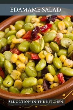 a bowl filled with green olives and red peppers